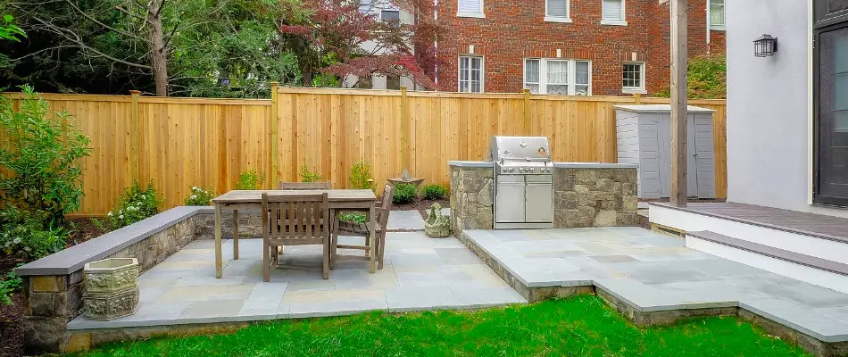 A 3D rendering of an outdoor kitchen, patio, and seating wall in Chevy Chase, MD.