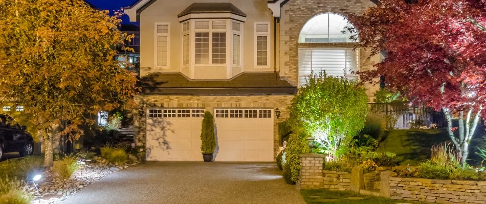 Front yard landscaping illuminated with lights in Chevy Chase, MD.