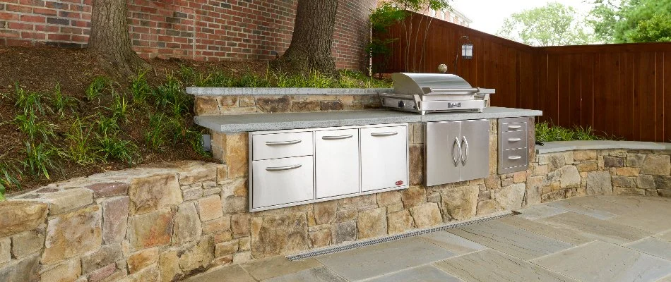 Outdoor kitchen with grill at a home in Chevy Chase, MD.