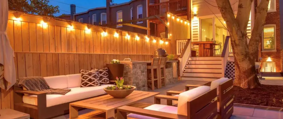 An illuminated outdoor kitchen on a patio in Chevy Chase, MD.