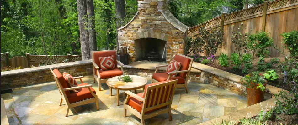 Patio in Aspen Hill, MD, with chairs, fireplace, and seating wall.