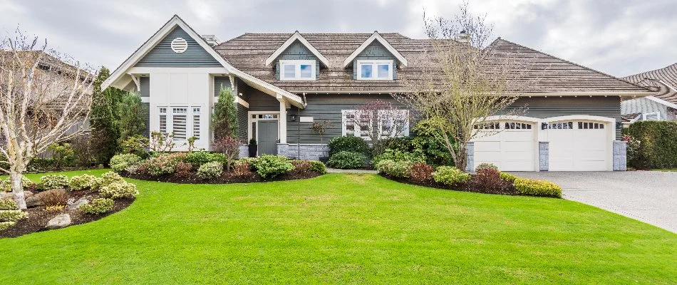 Lawn with green grass and manicured landscape beds in Chevy Chase, MD.