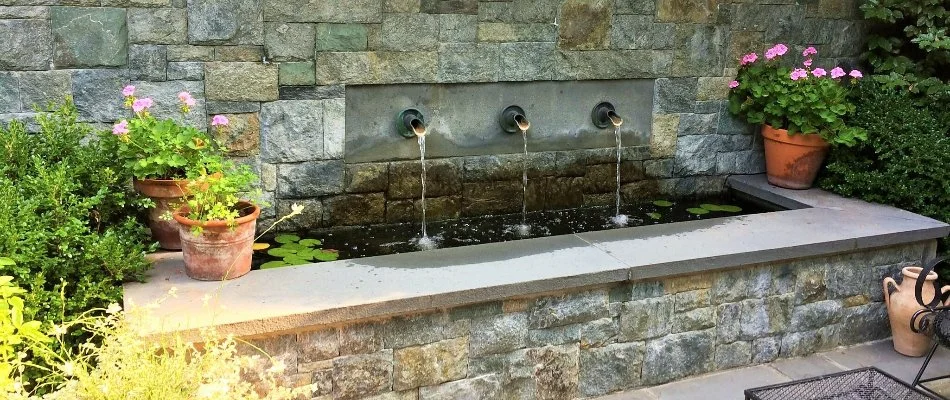 Water feature installed in stone wall near Chevy Chase, MD.