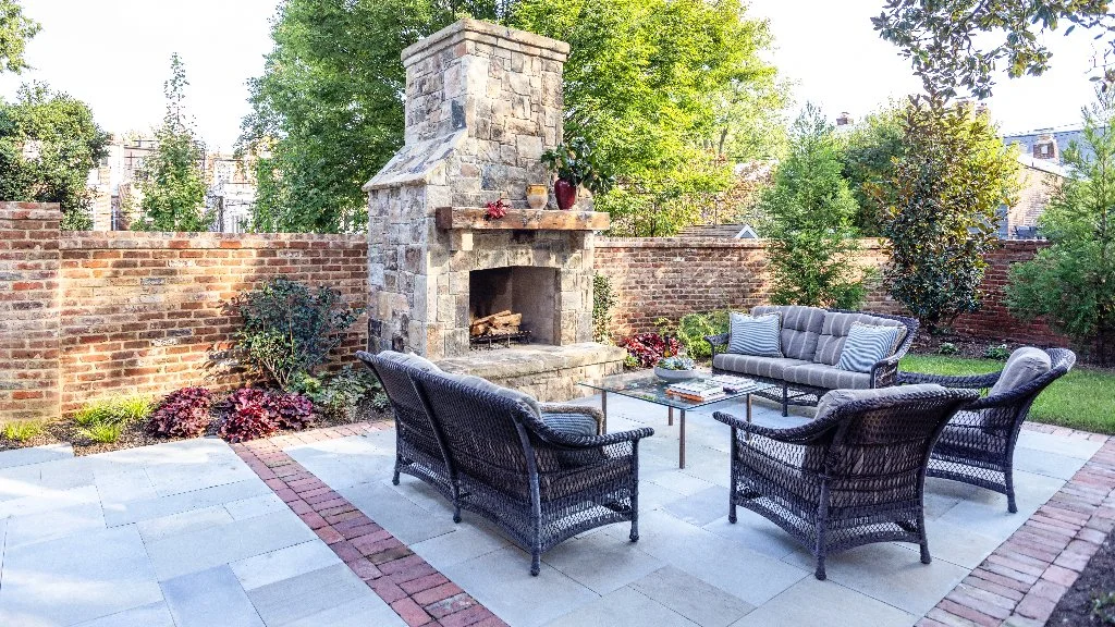 Outdoor living space in McLean, MD, with a patio and fireplace.