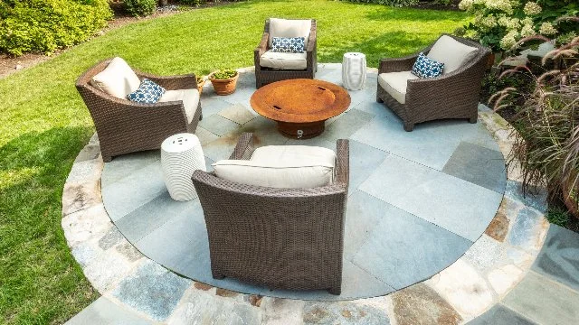 A circular paver patio in Chevy Chase, MD, with outdoor seating.