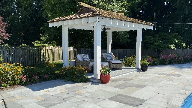 Backyard in McLean, VA with a small pavilion by the pool.